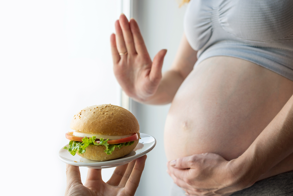 O femeie însărcinată care spune nu unui burger